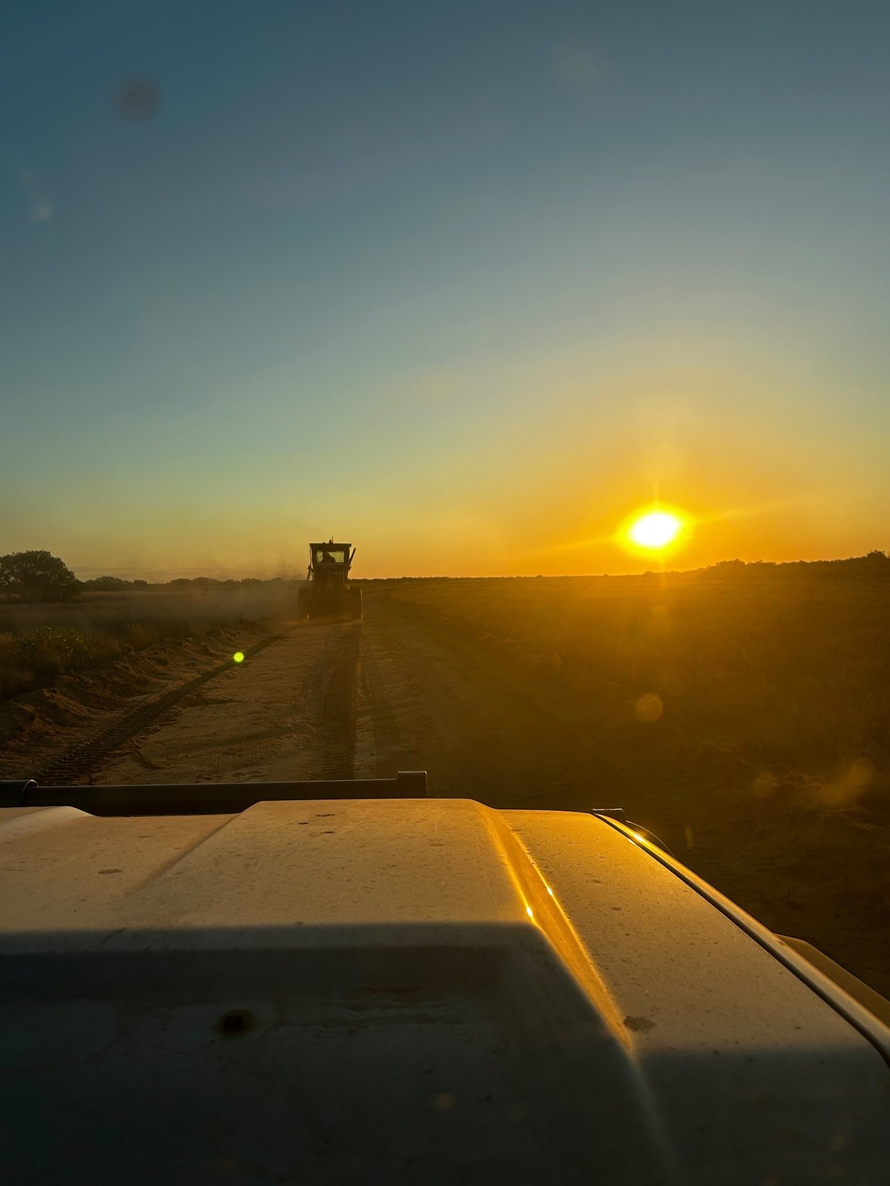 Kimberley Earthmoving grader working at sunset
